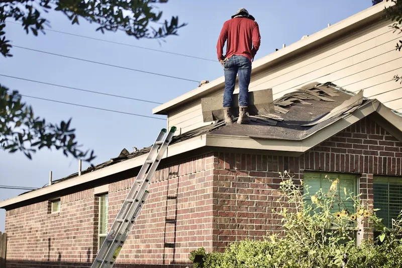 Professional roofer working on a residential roof in Etchison